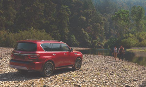2023 Nissan Armada Red parked lakeside